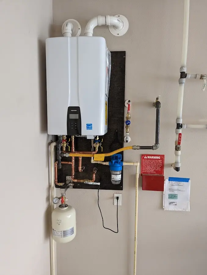 Professional plumber installing copper piping in a Barnegat home